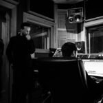 sound engineer creating musical arrangement on computer in recording studio
