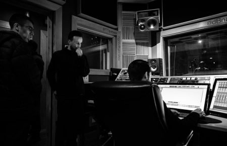 sound engineer creating musical arrangement on computer in recording studio